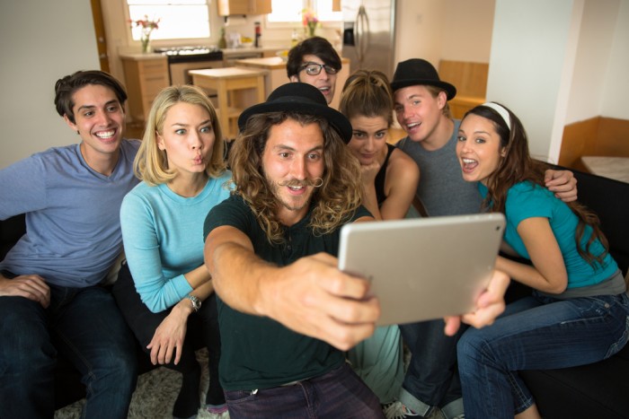 Group of millennials taking a selfie